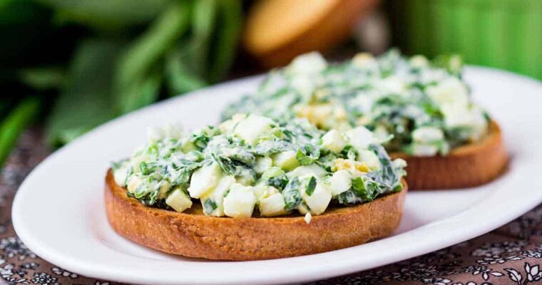 Sandwich with eggs salad, green herb, parsley, ramson, spring onions